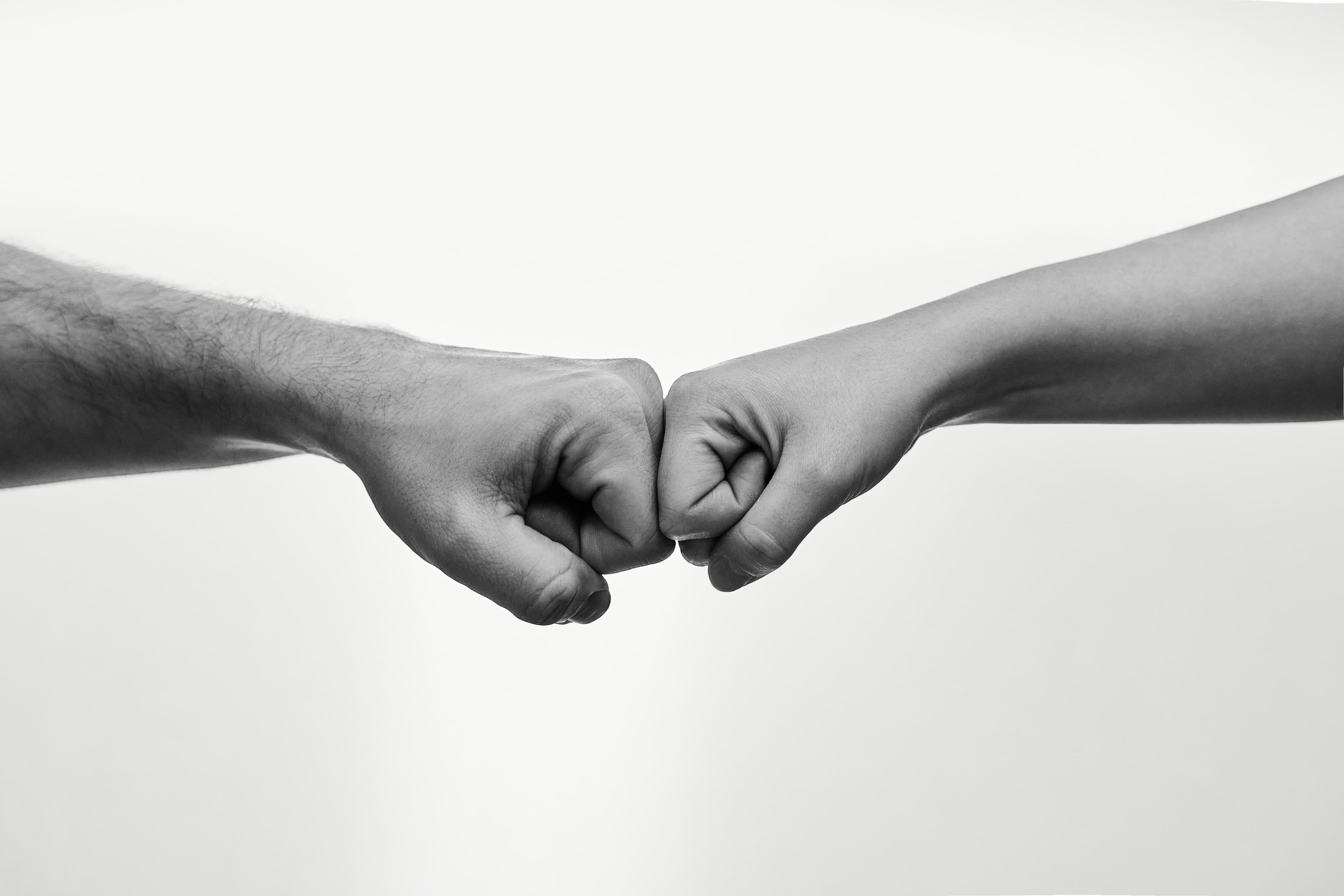 Two fists bumping